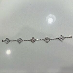 Custom VCA-inspired dazzling silver bracelet with 60 zircon stones.